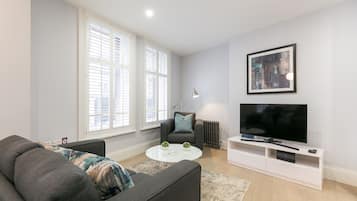 Standard One Bedroom Apartment | Living area | Flat-screen TV