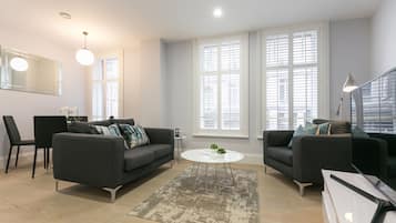 Standard One Bedroom Apartment | Living area | Flat-screen TV