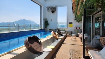 Outdoor pool, open 7:00 AM to midnight, pool umbrellas, sun loungers