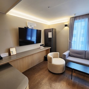 Relax in this stylish room with a flat-screen TV, refrigerator, and comfortable seating area.