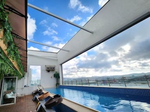 Outdoor pool, open 7:00 AM to midnight, pool umbrellas, pool loungers