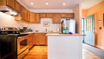 Enjoy cooking in this well-equipped kitchen with an island, double oven, and coffee maker.
