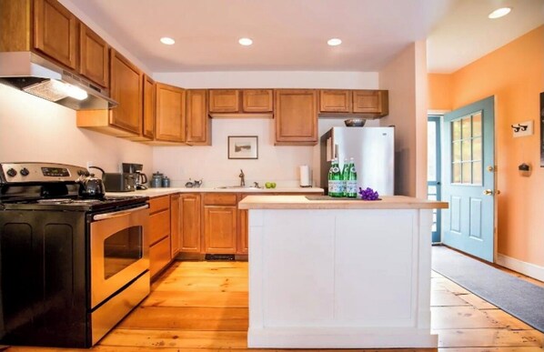 Enjoy cooking in this well-equipped kitchen with an island, double oven, and coffee maker.