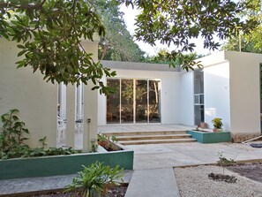 Step into a serene outdoor oasis surrounded by lush greenery and a tranquil atmosphere.