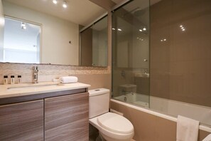 Bathtub, hair dryer, towels, shampoo