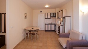 A compact living space with a kitchenette, a dining area with a table and chairs, and a seating area with a sofa. - Dream Holiday Aparthotel (Nessebar)