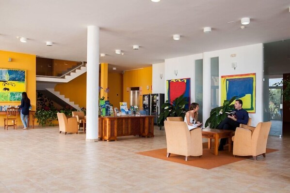 A spacious lobby with a staircase, a reception desk, and seating areas. - La Caleta (Brena Baja)