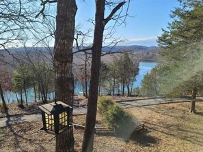 Surrounded by a serene lake and distant mountains, this peaceful setting offers a tranquil escape for nature appreciation.