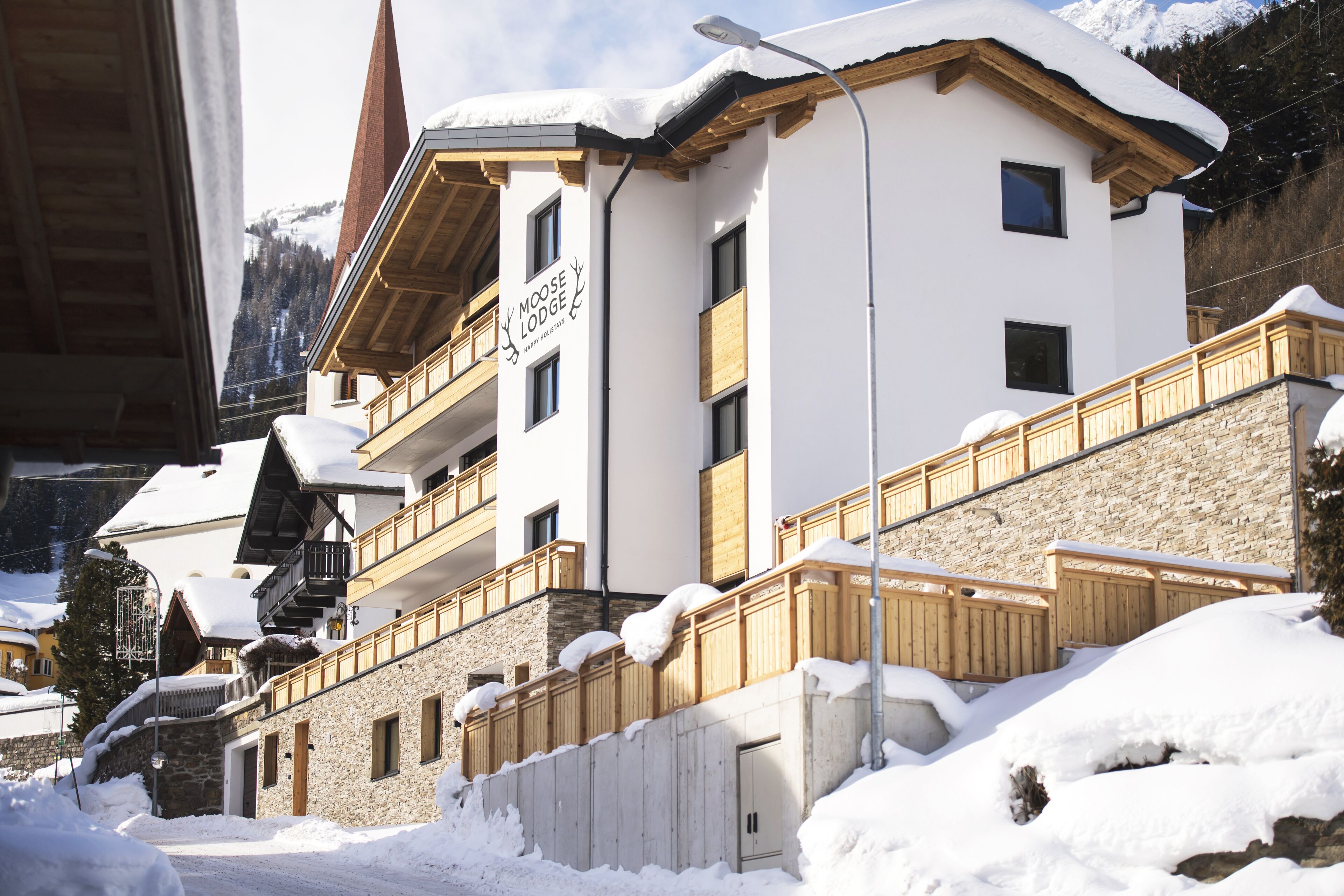 A two-story building with a sign reading 'Moose Lodge Happy Holidays.'