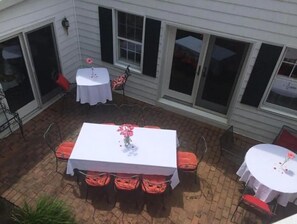 Enjoy al fresco dining in this inviting patio area, complete with a central table and comfortable seating.