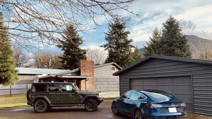 A garage with a car parked inside. - Packwood’s BaseCamp@MtRainier 2bd/2bth-pets (Packwood)