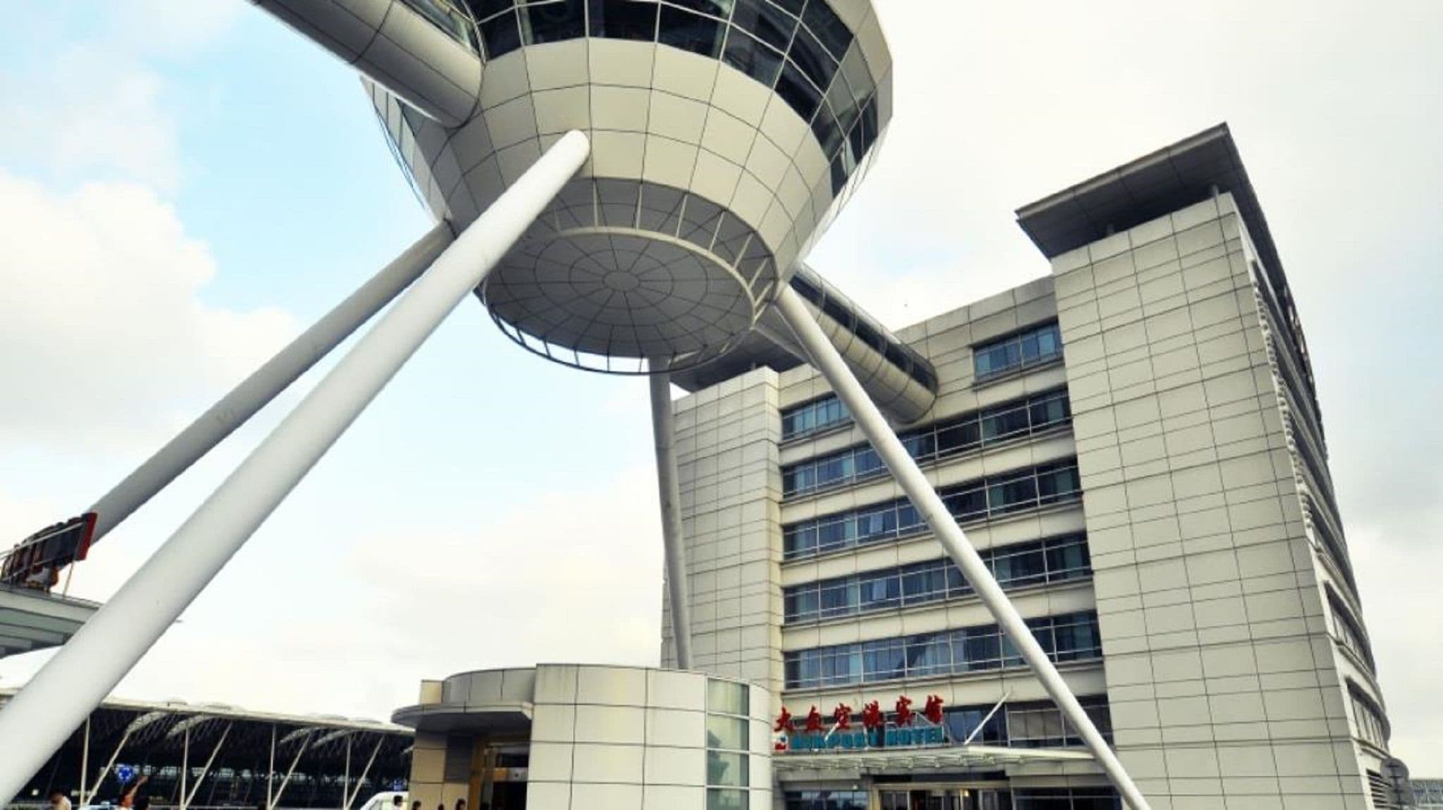 Un bâtiment moderne doté d’une tour cylindrique et d’une structure à toit plat.