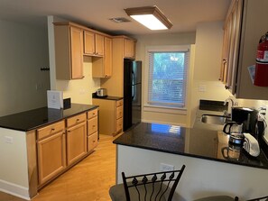 Full-sized fridge, microwave, dishwasher, coffee/tea maker