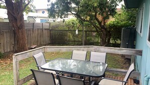 A covered patio with a glass table and four chairs. - The Beach Shack - Queenscliff (Queenscliff)