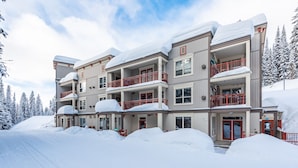 A multi-story hotel with balconies and a snow-covered exterior.