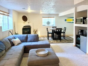 Cozy living space with a sofa, dining area, and fireplace.