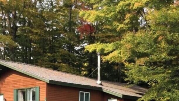 A cabin with a fire pit and Adirondack chairs in the yard. - Killington / Rutland 2 bedroom Cabin, Cabin #2 (Mendon)