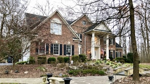 A brick house with a stone pathway, a small bridge, and a well-maintained garden. - Gorgeous, Wooded 3 Acre Estate -5 Bed/4  Bath-Leesburg/Brambleton/Aldie area (Leesburg)