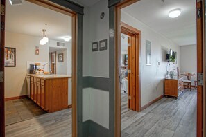 A modern kitchen with wooden cabinets, a central island, and a pendant light.
