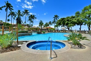 A swimming pool with a hot tub, surrounded by palm trees and lounge chairs. - Ground Floor Garden Studio - Kaanapali Villas B143 (Lahaina)