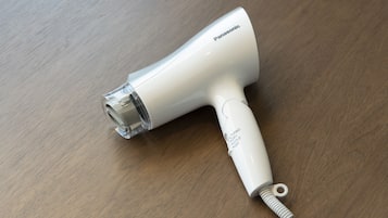 A Panasonic hair dryer on a wooden surface.
