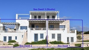 A modern two-story building with balconies, labeled as Sea Swell 1, 2, and 3 (Studio). - Sea Swell Villa 2 - stylish home with shared pool (Santa Maria)