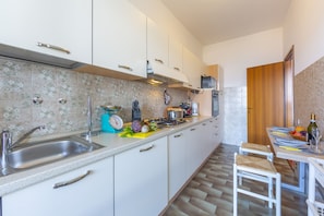 Apartamento família, vários quartos, ao lado da montanha (La Rosa Dei Venti Lake View Terrace) | Cozinha privada | Geladeira, micro-ondas, fogão, cooktop