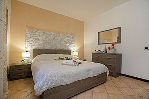 Family Apartment, 1 Bedroom, Microwave (Borgo Degli Ulivi - 200m to the Lake) | 1 bedroom, iron/ironing board, free WiFi, bed sheets