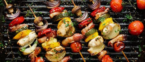 A variety of grilled vegetables and meats on a grill.