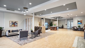 A spacious lobby with a modern design, featuring a sofa, chairs, a coffee table, and a patterned rug. - Candlewood Suites Asheville Downtown by IHG (Asheville)