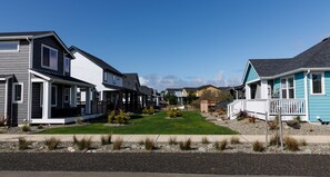 Homes in a residential neighborhood with various architectural styles and well-manicured lawns.