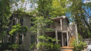 A two-story house with a balcony and a staircase leading to the second floor. - Chic Condo | Queen Suite | Walk to Shops & Dining | Near Lake Tahoe (Kings Beach)