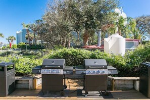 Enjoy al fresco dining with two gas grills on a spacious deck surrounded by lush landscaping.