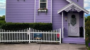 A purple house with a white picket fence, a front porch, and a mailbox. - Sunrise Above Ober, Hot Tub and Two Decks (Gatlinburg)