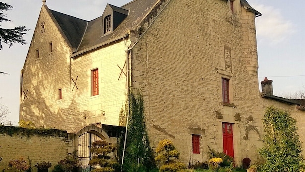 A large stone building with a steep roof, multiple windows, and a well-maintained lawn in front. - Gite du Manoir des Roches (SAIRES)