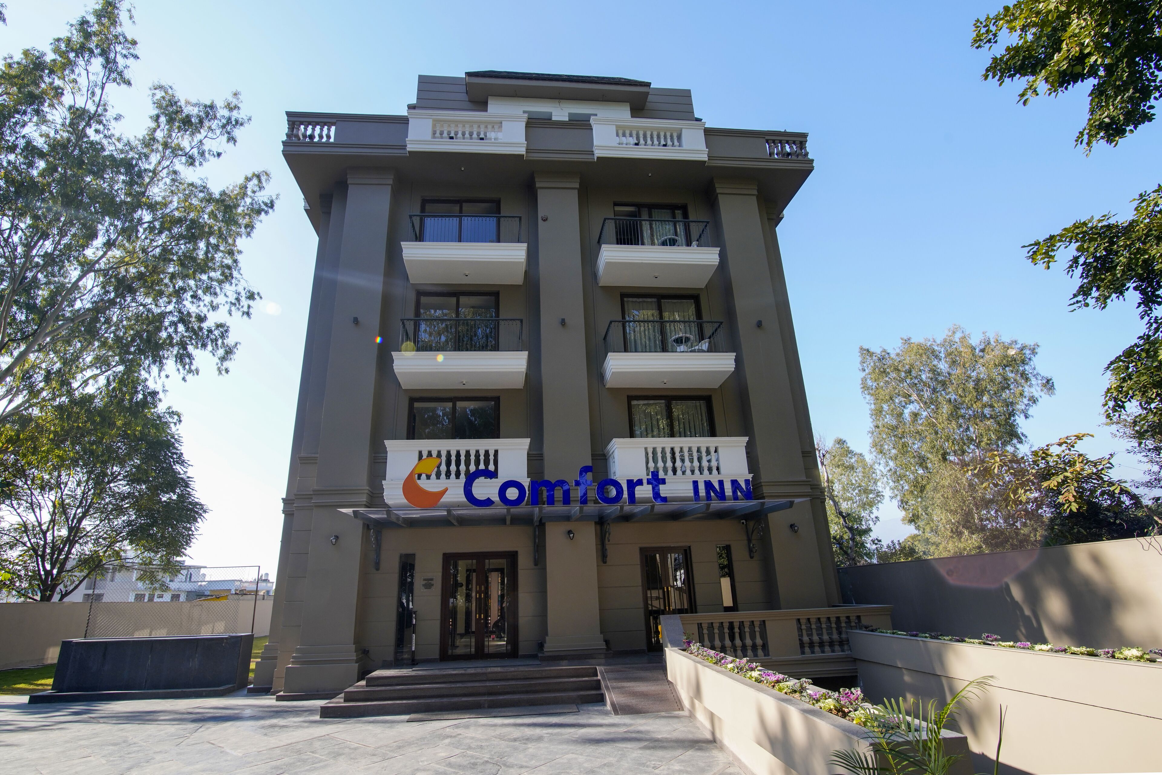A multi-story building with a sign reading "Comfort Inn".