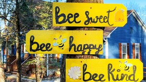 A yellow sign with the words "bee sweet," "bee happy," and "bee kind" on a tree. - Cozy Cabin with Mountain Views, Pet Friendly, 3 Miles from Downtown Highlands (Highlands)