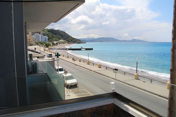 Enjoy breathtaking views of the ocean and beach from this hotel room.