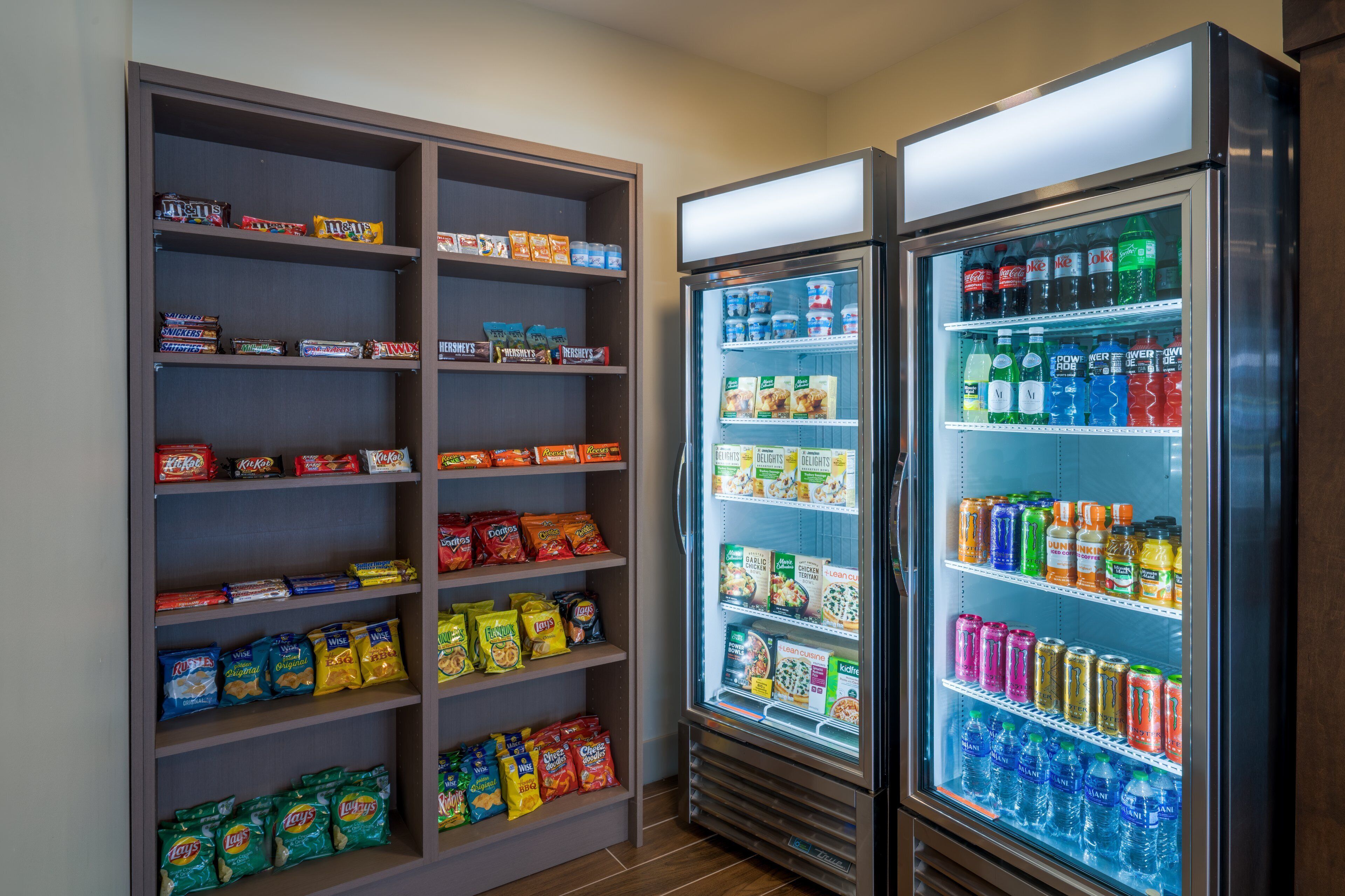 A snack and beverage refrigerator stocked with various snacks and drinks.