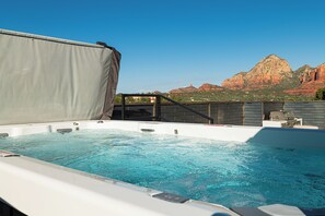 A hot tub with a view of red rock formations.