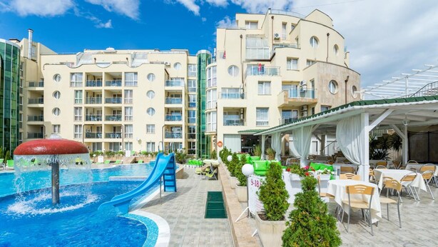 A hotel with a swimming pool, outdoor seating, and multiple balconies. - Apart Hotel Vechna R (Nessebar)