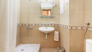 A bathroom with a bathtub, sink, and toilet.