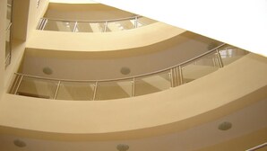 A multi-level interior with curved balconies and glass railings. - Apart Hotel Vechna R (Nessebar)
