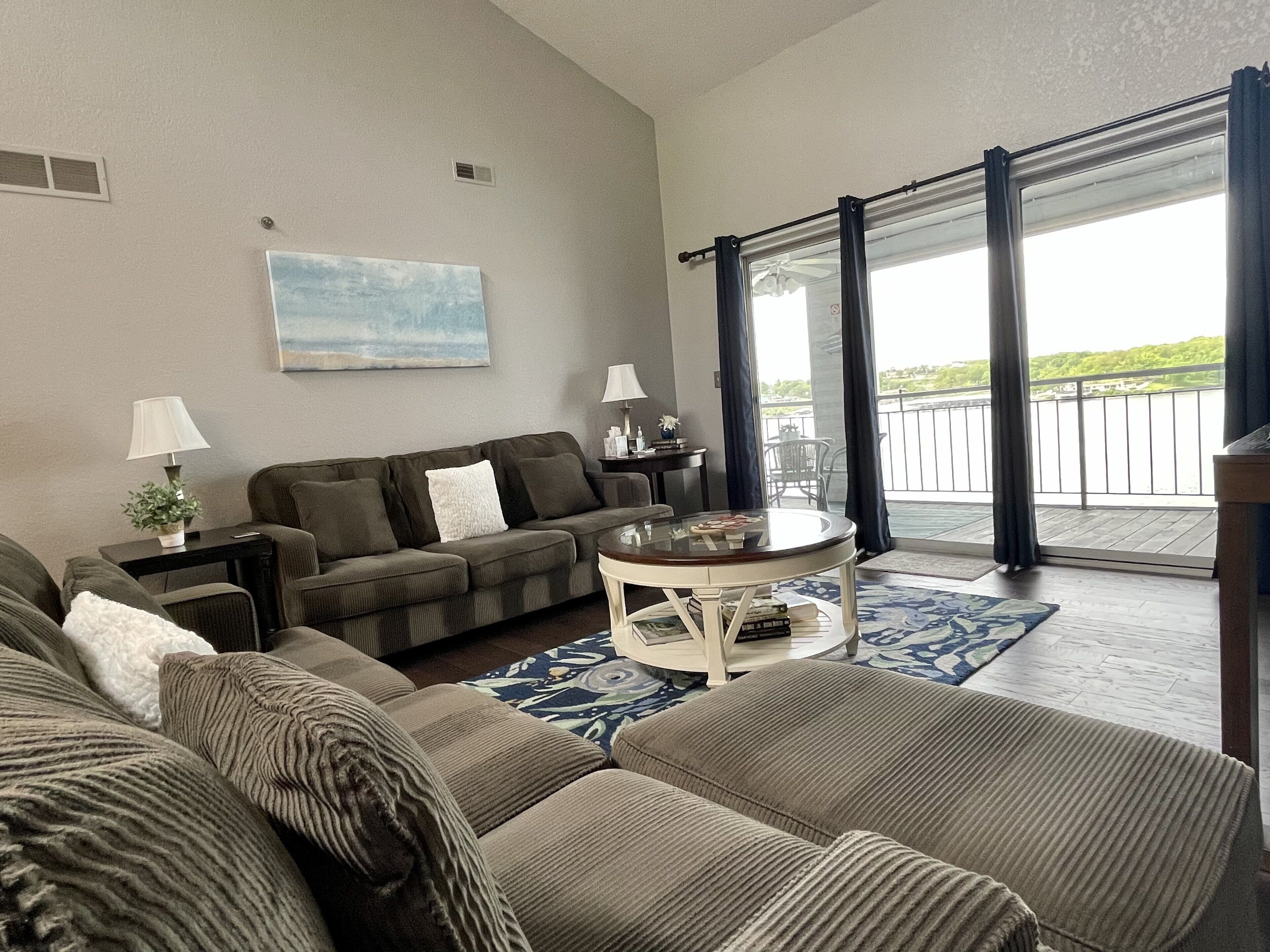 Admire the tranquil lake view in this comfy living space 