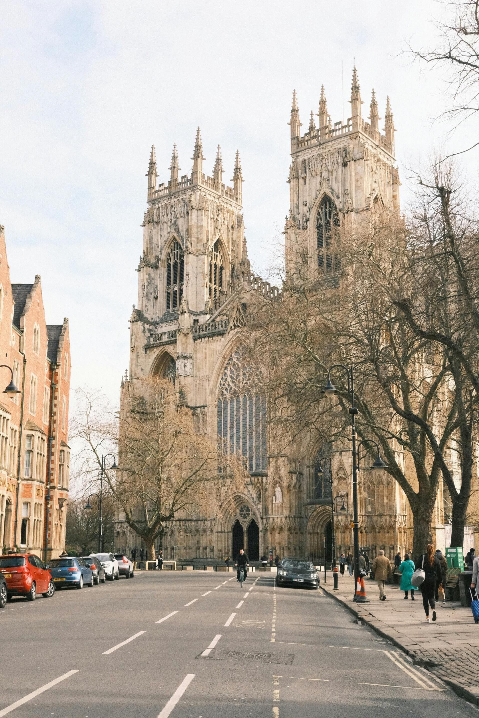 A historic cathedral with Gothic architecture, featuring two prominent towers and large arched windows.