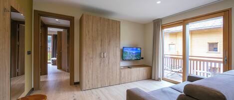 Family Apartment, 2 Bedrooms (Casa Luminosa Ski in -Ski out 100m) | Living room | 21-inch flat-screen TV with satellite channels, TV, fireplace