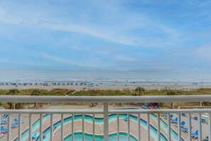 Enjoy a beachside view from your balcony overlooking the pool and the ocean.