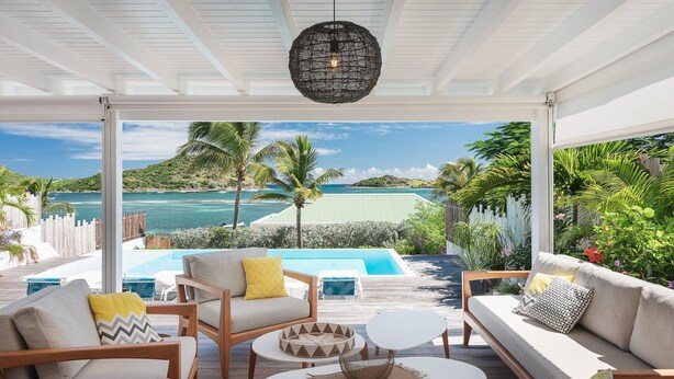 A covered outdoor seating area with a view of a pool and ocean. - A dream villa for an unforgettable vacation! (Cul-de-Sac)