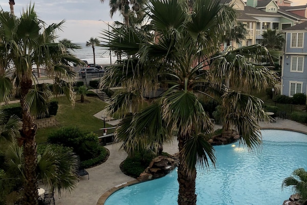 View from our 3rd story balcony - beach and pool.