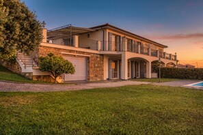 A two-story house with a stone facade, a garage, and a swimming pool. - Villa Lucia Riviera dei Fiori, Sea-view and Pool (Sanremo)